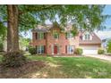 Charming two-story brick home featuring a well-manicured lawn at 111 Harris Farm Rd, Mooresville, NC 28115