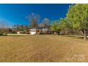 Spacious brick home with an attached garage surrounded by a lush green lawn and trees at 1139 Suttle Rd, Lancaster, SC 29720