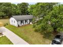 An elevated view of a cozy home with a lush green lawn, mature trees, and private drive at 1316 Fox Run Dr, Charlotte, NC 28212
