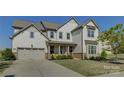 Charming two-story home featuring a neutral color palette, well-manicured lawn, and an attached two-car garage at 14229 Twin Eagles Ln, Charlotte, NC 28278
