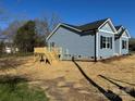 Charming blue house featuring a wooden deck and manicured lawn at 1501 School Ave, Gastonia, NC 28052