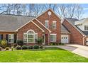 Charming brick home features an attached garage, well-maintained landscaping, and a traditional design at 176 Columns Cir, Shelby, NC 28150