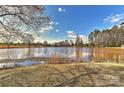 Scenic view of a tranquil pond surrounded by trees and open space at 2013 Barkley Cir, Monroe, NC 28112