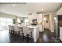 Bright kitchen with white cabinets, quartz countertops, stainless steel appliances, and an island with seating at 3014 Bramble Hedge Rd # 3270, Indian Trail, NC 28079