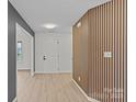 Hallway featuring wood-look floors and a decorative wall panel at 3919 Chatterleigh Dr, Monroe, NC 28110