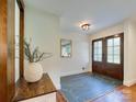 Welcoming foyer featuring slate flooring, double doors, stylish mirror, and a decorative accent piece at 4216 Maureen Dr, Charlotte, NC 28205