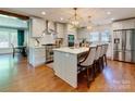 Elegant kitchen featuring a large island, stainless steel appliances, and modern lighting at 4216 Maureen Dr, Charlotte, NC 28205