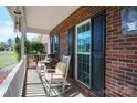 Inviting front porch with rocking chairs and brick exterior offering a cozy outdoor space at 4436 Roberta Rd, Concord, NC 28027