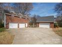 Multiple garage spaces with a wide driveway enhance this brick home's functionality and curb appeal at 4436 Roberta Rd, Concord, NC 28027