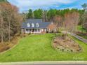 An impressive brick home boasts a pristine lawn, mature trees, and an inviting front porch at 514 Saint Johns Dr, Salisbury, NC 28144