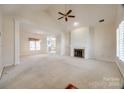 Spacious living room with vaulted ceiling, fireplace, and lots of natural light at 7124 Bevington Woods Ln, Charlotte, NC 28277