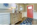 Inviting foyer with hardwood floors, a stylish accent rug and a decorative wood dresser at 7645 Bainbridge Rd, Sherrills Ford, NC 28673