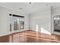 Living room with hardwood floors, a balcony, and access to the bathroom at 792 N Davidson St, Charlotte, NC 28202