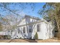 Charming home with white brick exterior, multi-pane windows, and manicured landscaping at 8142 Cliffside Dr, Charlotte, NC 28270