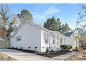 Home exterior featuring landscaping, a sidewalk, and crisp white paint at 8142 Cliffside Dr, Charlotte, NC 28270