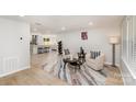 Open-concept living room with stylish decor, wood flooring, and seamless flow to the kitchen at 9105 Touchstone Ln, Charlotte, NC 28227