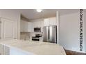 Bright kitchen featuring stainless steel appliances, white cabinets, and a marble island at 942 Saturn St, Gastonia, NC 28052