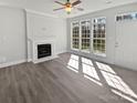 Bright living room with fireplace, large windows, and hard wood flooring at 9832 Veronica Dr, Charlotte, NC 28215