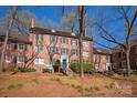 Exterior view of a three story brick building with stairs leading to front door at 103 S Laurel Ave, Charlotte, NC 28207