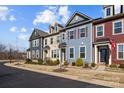 Street view of inviting townhomes with colorful exteriors, manicured lawns, and a peaceful community setting at 11332 Westbranch Pkwy, Davidson, NC 28036