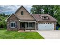 Charming home featuring a combination of stone and shingle siding with an attached two-car garage at 1263 Waterford Dr, Hickory, NC 28602