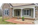 Charming front porch with brick accents and decorative potted plant. The house number is visible above the front door at 1263 Waterford Dr, Hickory, NC 28602