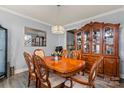 Traditional dining room featuring gray walls, hardwood floors, and a chandelier at 12836 Harvest Time Ct, Charlotte, NC 28278