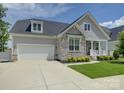 Beautiful home featuring stone accents, a two-car garage, and a well-maintained front lawn at 14230 Morningate St, Huntersville, NC 28078
