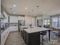 Spacious kitchen featuring a large island, stainless steel appliances, and ample cabinet space at 14230 Morningate St, Huntersville, NC 28078