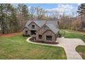 Sprawling single-Gathering home with brick and stone finishes, set on a large lot with meticulously maintained landscaping at 1770 Cranwell Dr, Mt Ulla, NC 28125