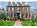 Classic brick facade with dormer windows and black shutters, framed by a well-kept green lawn at 1801 Maryland Ave, Charlotte, NC 28209