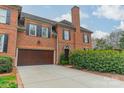 Brick home featuring a large garage, well-maintained lawn and driveway at 1801 Maryland Ave, Charlotte, NC 28209