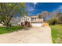 Inviting home featuring a long driveway and a well-maintained lawn on a sunny day at 1812 Rosewell Dr, Rock Hill, SC 29732