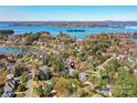 Breathtaking aerial view showcasing the property's location near Lake Norman, surrounded by lush trees and upscale homes at 18512 Square Sail Rd, Cornelius, NC 28031