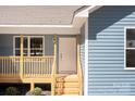 Close up of the front porch featuring wooden steps and railings with blue siding at 186 Byers Rd, Troutman, NC 28166