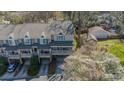 An aerial view of the townhome showcasing its roof line, attached garage, and proximity to trees and outdoor space at 2953 Craftsman Ln, Charlotte, NC 28204