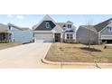 Traditional-style home boasts a two-car garage and a well-manicured lawn in a residential area at 2953 Findley Rd, Statesville, NC 28625
