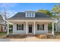 Charming single-story home featuring a welcoming front porch with elegant columns and a well-manicured lawn at 341 Bynum Ave, Rock Hill, SC 29732
