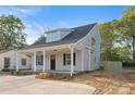 Beautiful exterior view showcasing gray siding, a covered front porch, and black door at 341 Bynum Ave, Rock Hill, SC 29732