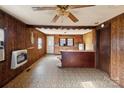 Open concept kitchen with wood paneling, tile floor, ceiling fan and wood cabinets at 3467 Clearview Ln, Maiden, NC 28650