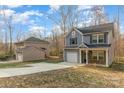Exterior of a two-story gray house with an extended driveway and a detached garage in the backyard at 3944 Wade E Morgan Rd, Charlotte, NC 28269