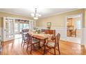 Elegant dining room with hardwood floors, chandelier, and french doors to sunroom at 600 S Central Ave, Belmont, NC 28012
