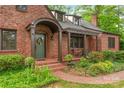 Beautiful brick home showcasing a covered front porch and landscaped garden at 600 S Central Ave, Belmont, NC 28012