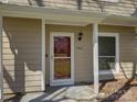 Welcoming front entrance featuring a glass storm door, exterior light fixture, and visible house number at 961 Sardis Cove Dr, Charlotte, NC 28270