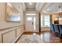 Elegant foyer with tray ceilings, hardwood floors, large windows, and decorative wainscoting at 1018 Heritage Pointe # 302, Indian Trail, NC 28079