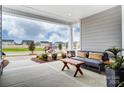 Open front porch area with comfortable seating and views of the neighborhood at 1018 Heritage Pointe # 302, Indian Trail, NC 28079
