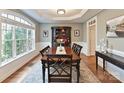 Elegant dining room with a large window, hardwood floors, and a classic wood table set at 1110 Woodhall Dr, Huntersville, NC 28078