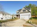 Inviting two-story home with a two-car garage and a well-manicured lawn at 11320 Joe Morrison Ln, Charlotte, NC 28214