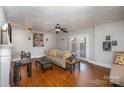 Cozy living room with hardwood floors, fireplace, and French doors leading to the outside at 116 S Westover Dr, Monroe, NC 28112