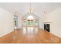 Spacious living room boasts hardwood floors, a vaulted ceiling, and a cozy fireplace at 126 Harbourtown Dr, Kings Mountain, NC 28086